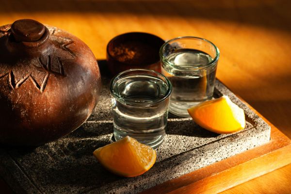 Capture the essence of Mexican tradition with tequila and citrus paired on a rustic tray.